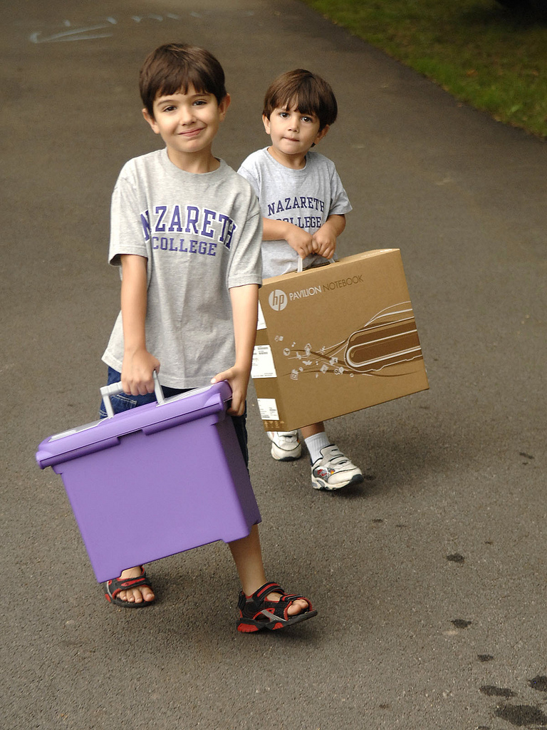 Kids carrying boxes